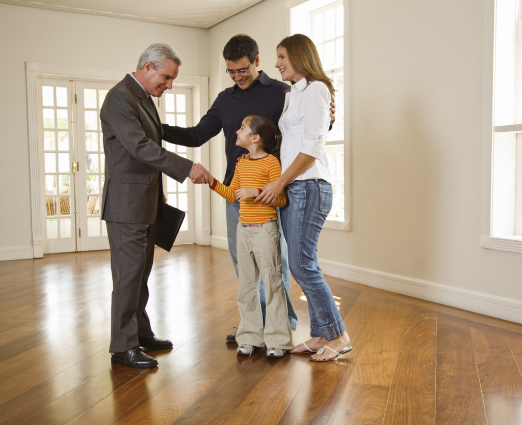 Family shaking hands with realtor